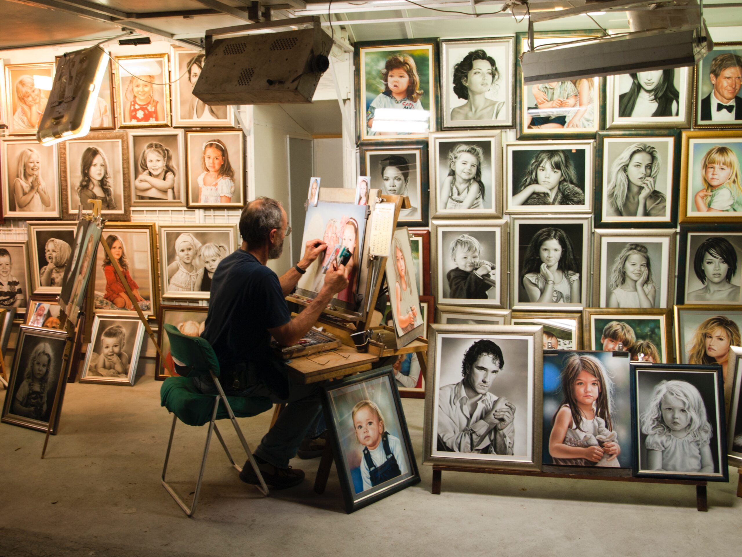 Artist surrounded by portraits - Visual Arts Essay Scaffold Featured Image