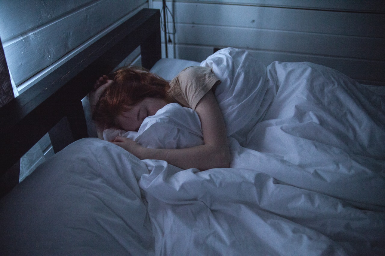 Girl struggling to sleep in her bed - Teenage Insomnia