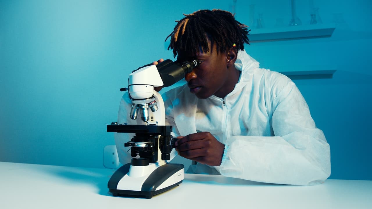 Man looking through microscope - qcaa biology student experiment