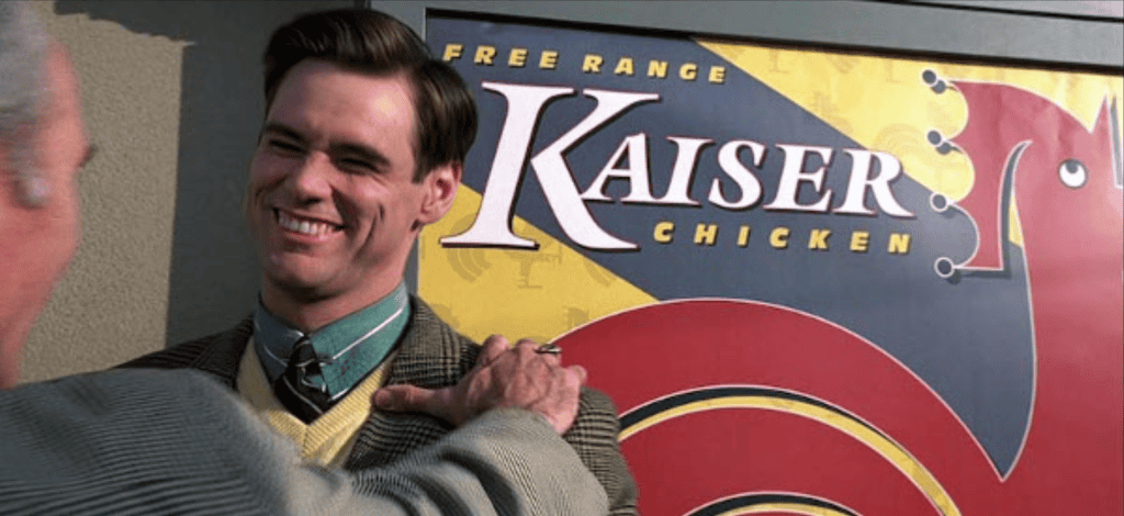 Truman being pinned up against a poster - The Truman Show Analysis