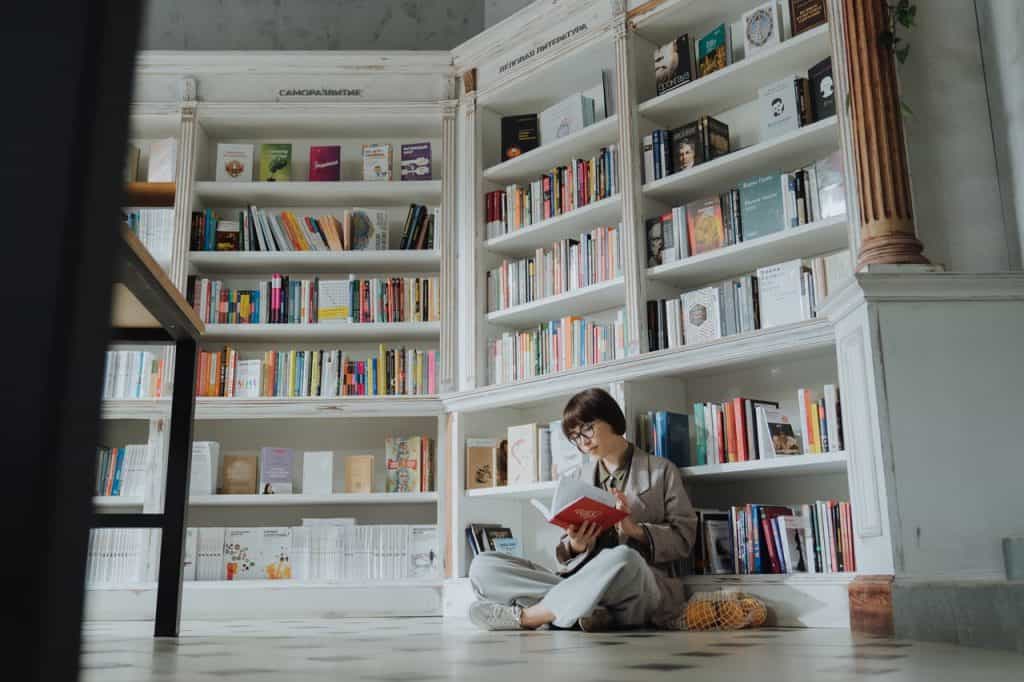 Person in a book store reading a book - Textual Analysis Featured Image