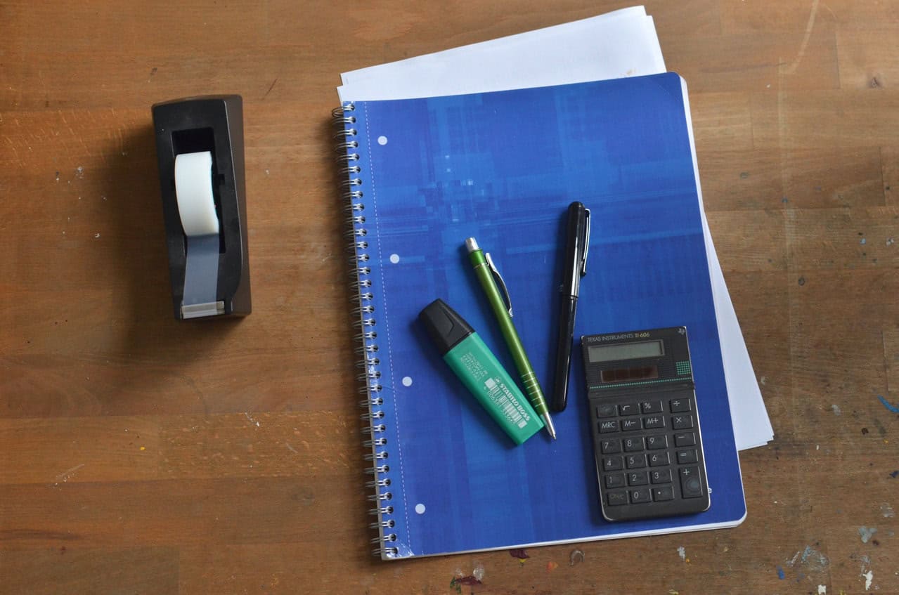 Stationery with a calculator on top of notebook - QCE General Maths Study Guide