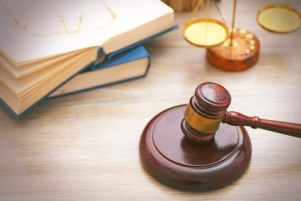 Gavel with justice scales and books on wooden table ,close up - VCE Legal Studies Study Design